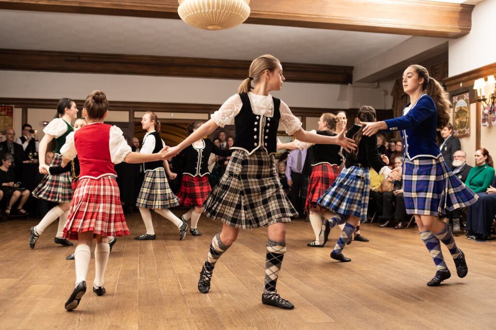 A group of highland dancers dancing in a circle